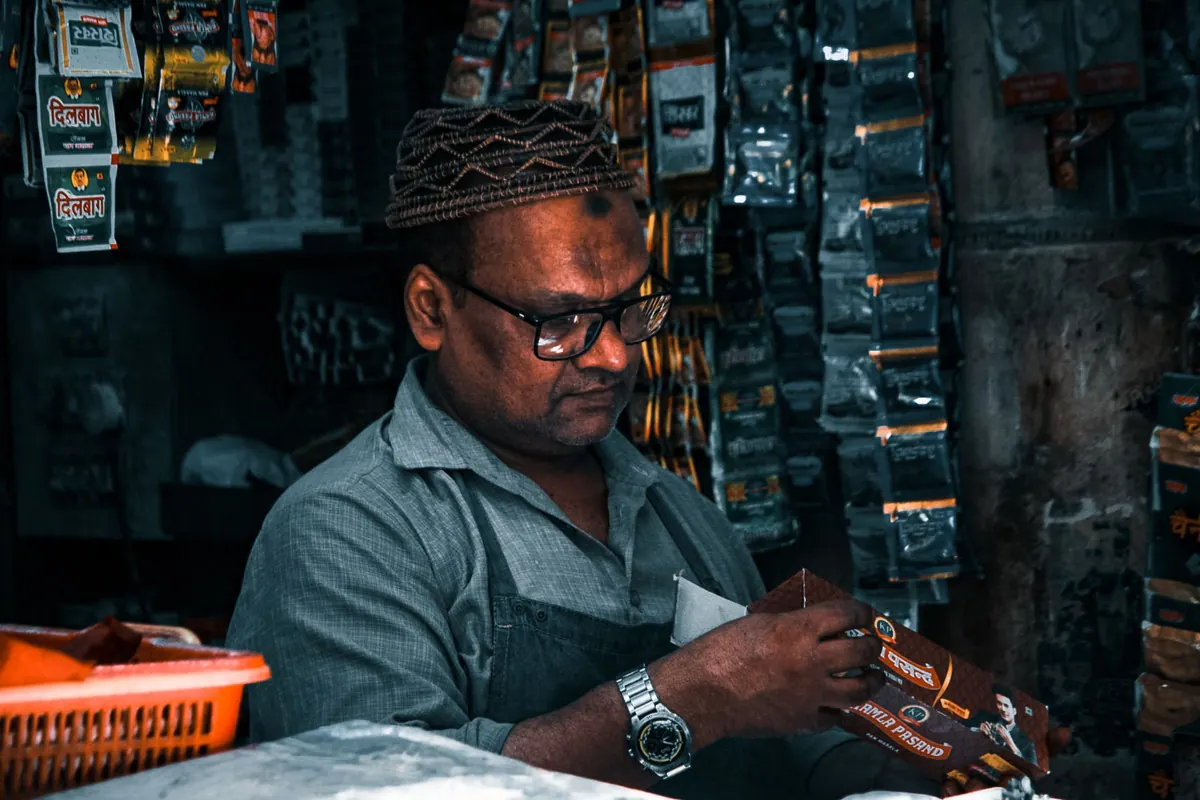 Shop owner organizing products on store shelves