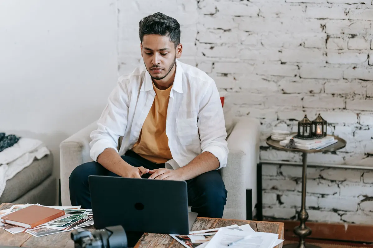 Independent professional working on a laptop at a home office desk
