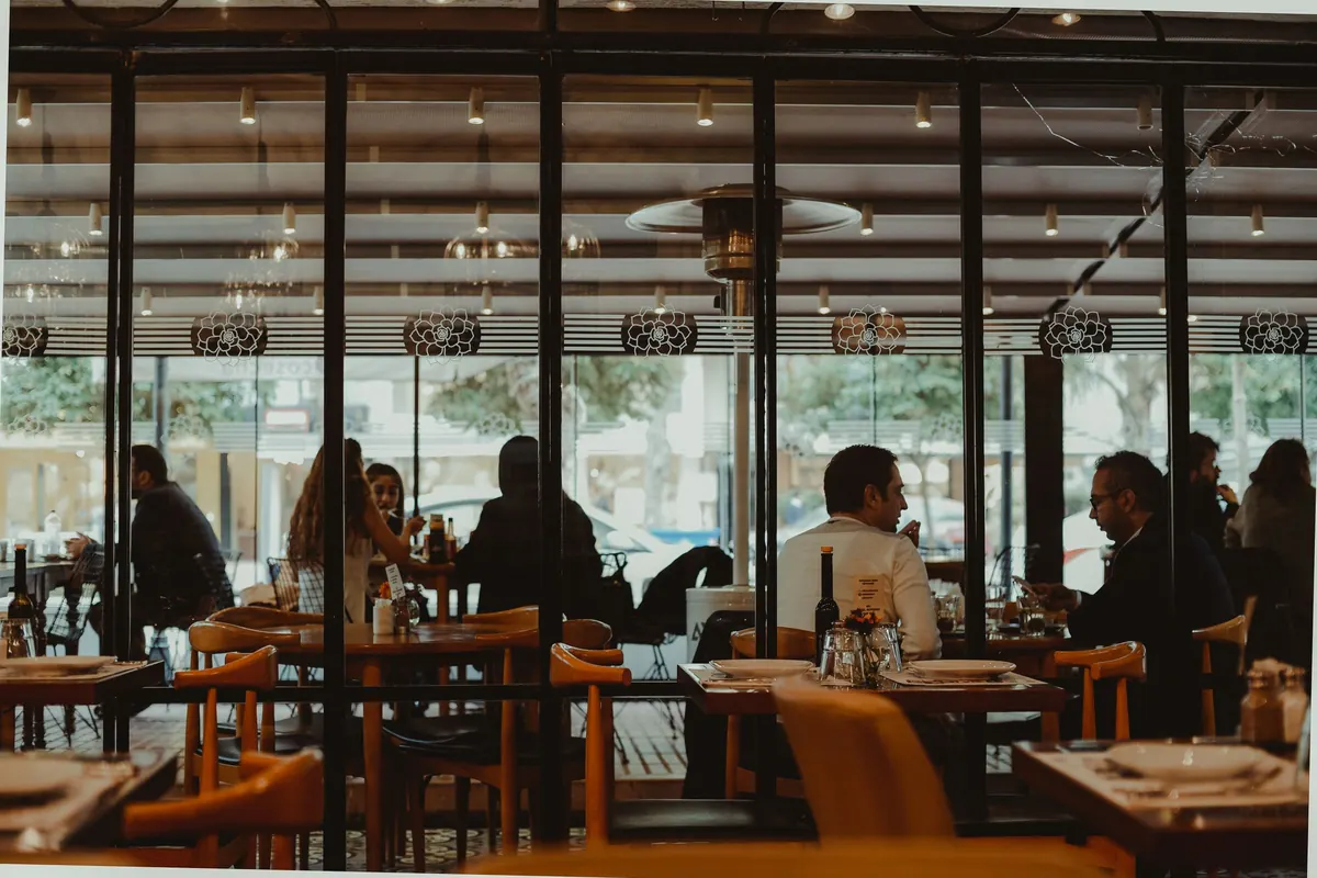 Busy restaurant dining room with guests at tables