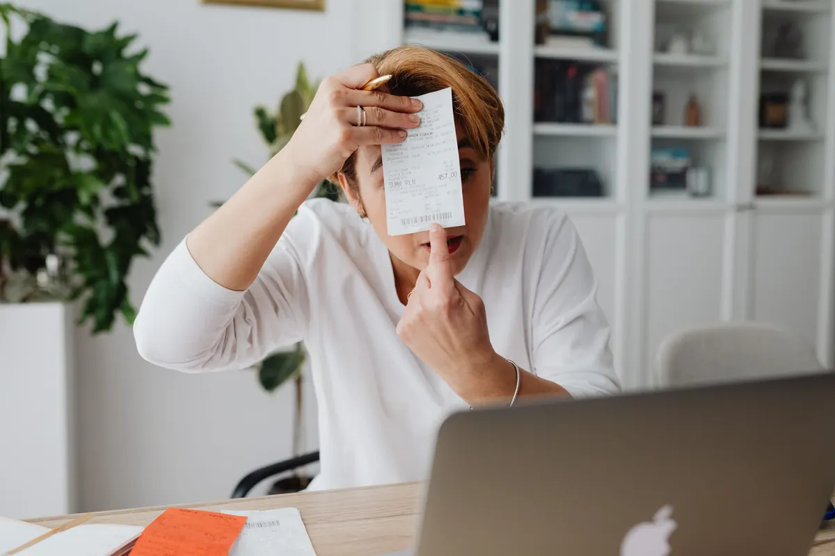 Businesswoman holding up a receipt