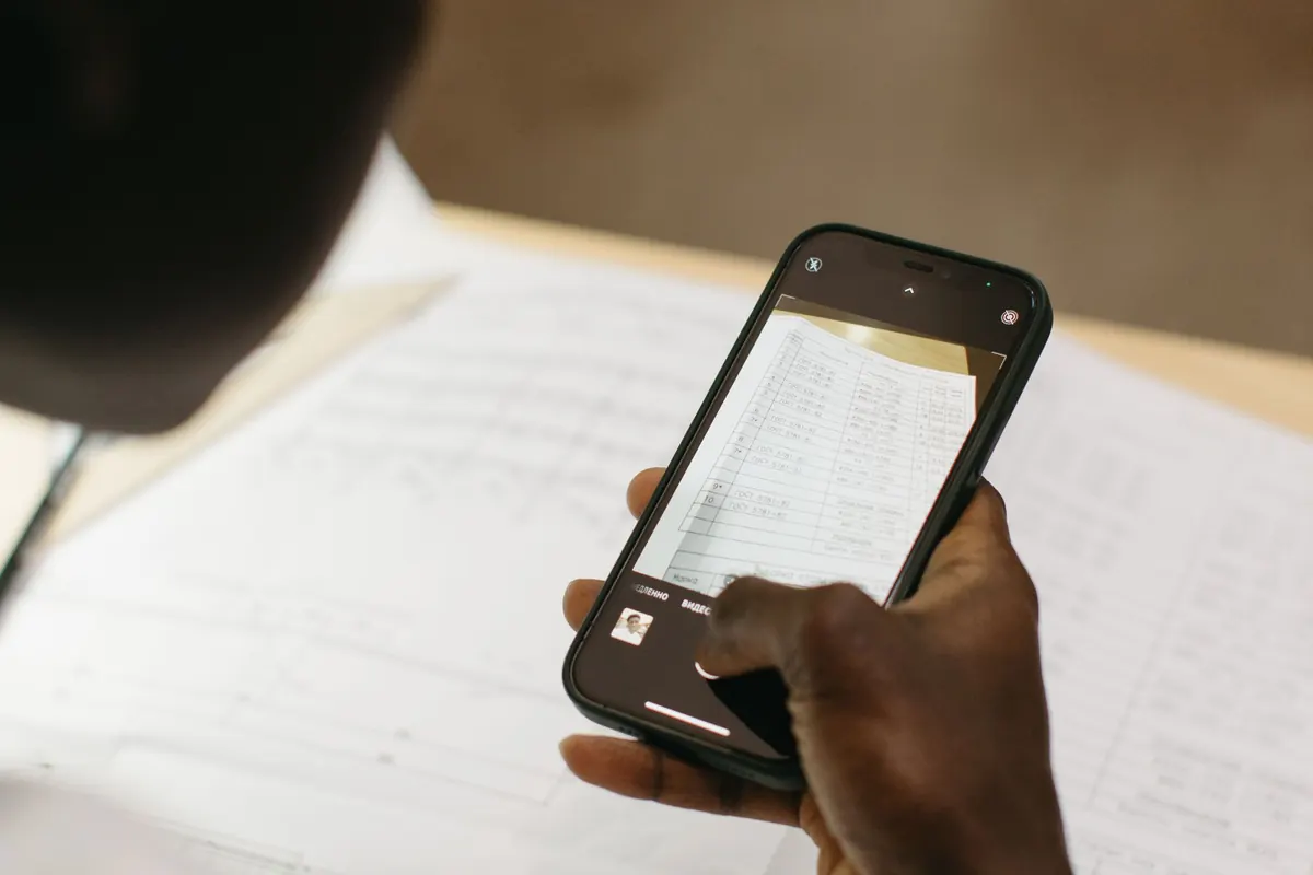 Person using a smartphone to scan a paper document