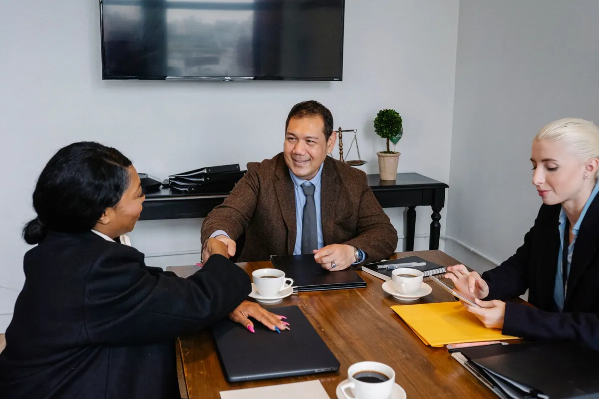 Business partners shaking hands to close a deal in an office