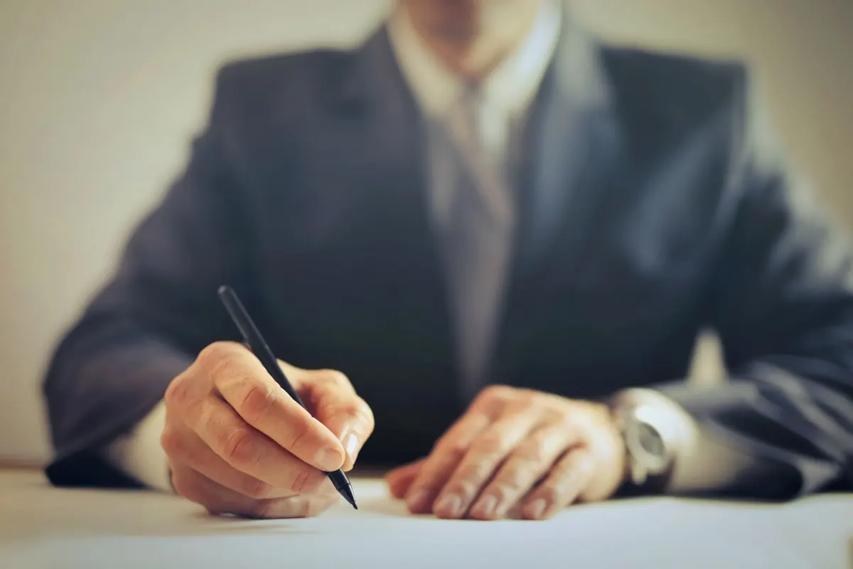 Businessman signing a document in an office