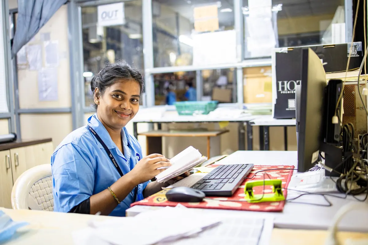 Employee reviewing documents at an office desk