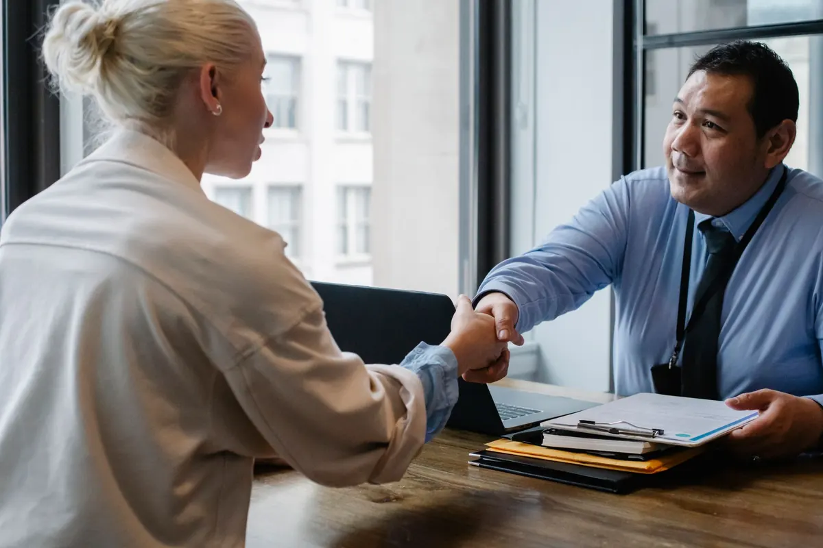 Businessman shaking hands with a job applicant